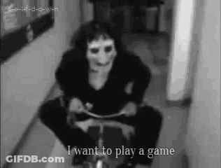 Black And White Photo Of Person In Mask Riding Bicycle GIF