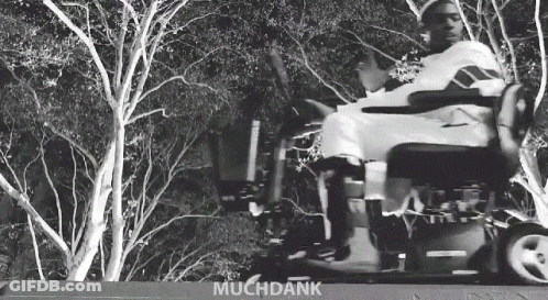 Black And White Photo Of Person In Wheelchair With Muchdank GIF