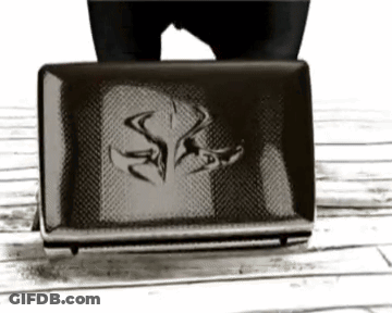 Black And White Photo Of Person Next To Wallet With Letter S GIF