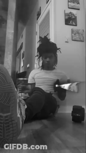 Black And White Photo Of Person Sitting In Hallway GIF
