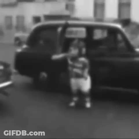 Black And White Photo Of Person Standing In Front Of Car GIF