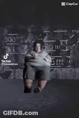 Black And White Photo Of Person Standing On Table In Dark GIF