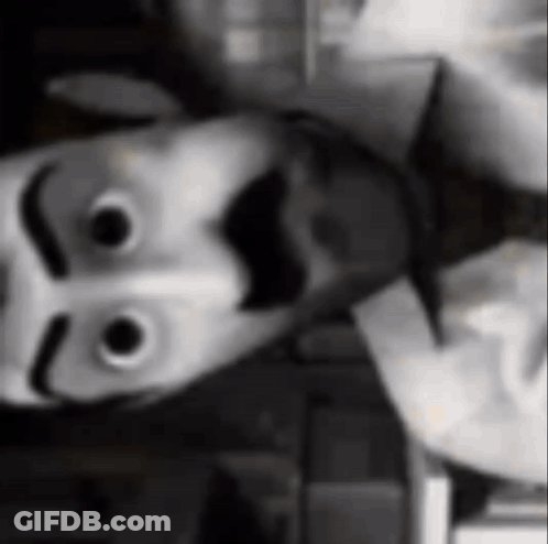 Black And White Photo Of Person Wearing Smiley Face Mask GIF