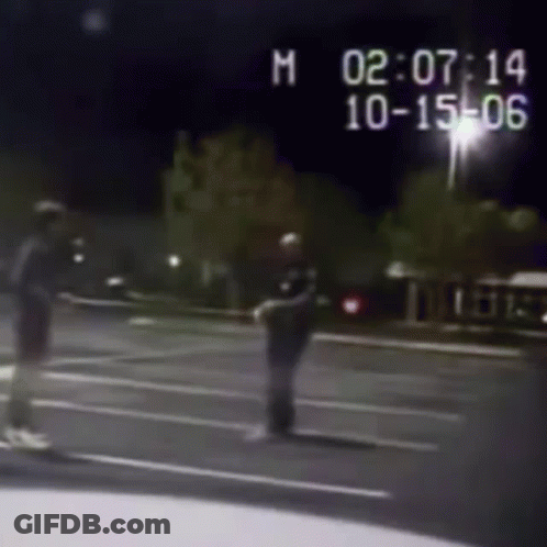 Black And White Photo Of Police Officer And Man On Street GIF