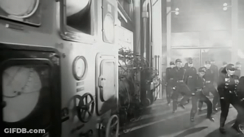 Black And White Photo Of Police Officers Running In Front Of Building GIF