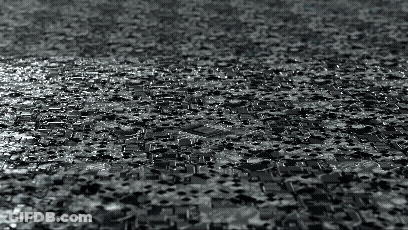 Black And White Photo Of Puzzle Pieces On Floor GIF