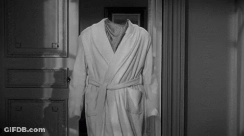 Black And White Photo Of Robe Without Head In Doorway GIF