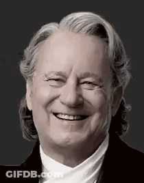 Black And White Photo Of Smiling Man With Gray Hair GIF