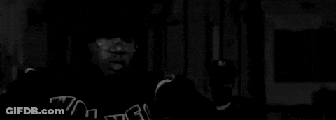 Black And White Photo Of Two Dogs On Sidewalk GIF