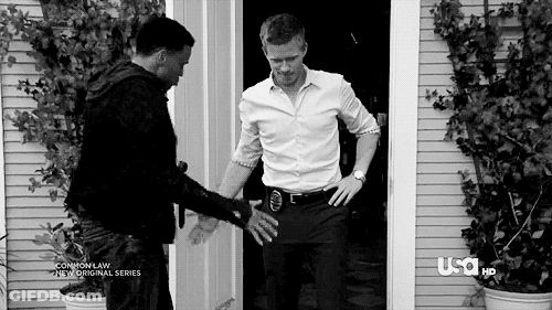 Black And White Photo Of Two Men In Front Of A Door GIF