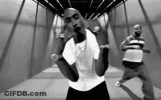 Black And White Photo Of Two Men In Hallway GIF