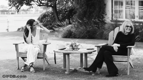 Black And White Photo Of Two Women Sitting On Lawn Chairs GIF