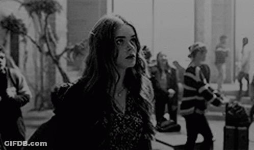 Black And White Photo Of Woman At Airport Window GIF