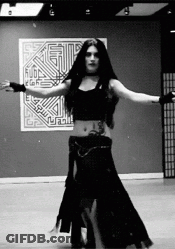 Black And White Photo Of Woman Dancing In Front Of Wall Saying Rubl GIF