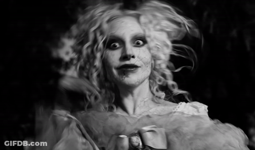 Black And White Photo Of Woman Dressed As Ghost GIF