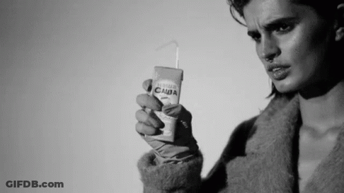 Black And White Photo Of Woman Holding Juice Box GIF