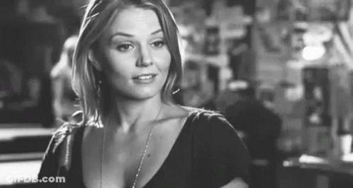 Black And White Photo Of Woman In Black Shirt And Necklace GIF