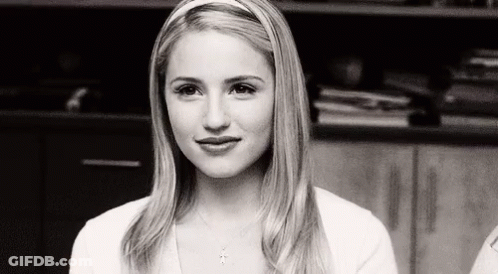 Black And White Photo Of Woman In Headband And White Shirt GIF