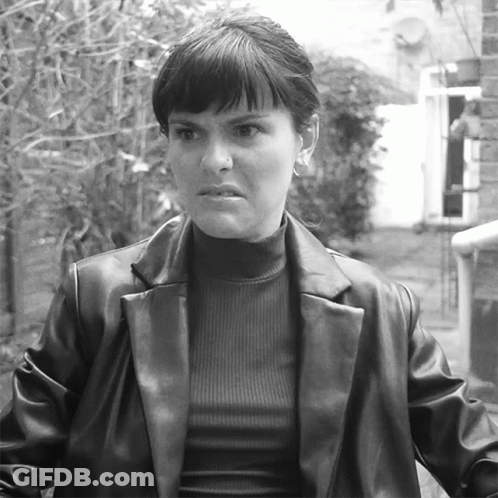 Black And White Photo Of Woman In Leather Jacket And Turtleneck GIF