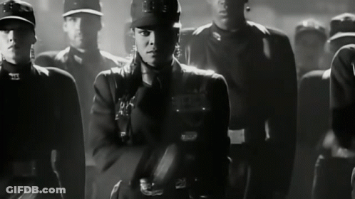 Black And White Photo Of Woman In Military Uniform With S On Hat GIF