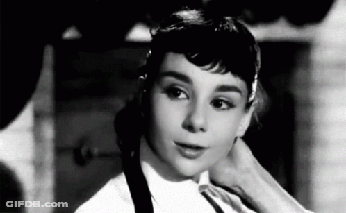 Black And White Photo Of Woman In White Shirt And Black Tie GIF