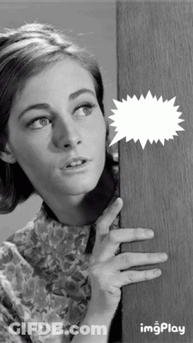 Black And White Photo Of Woman Peeking From Behind Door GIF