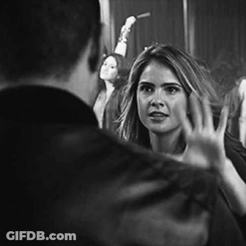 Black And White Photo Of Woman Waving At Man GIF