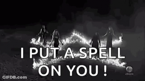 Black And White Photo Of Women Standing In Front Of Fire Spell GIF