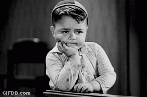 Black And White Photo Of Young Boy With Hand On Chin GIF