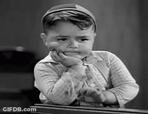 Black And White Photo Of Young Boy With Hand On Face GIF