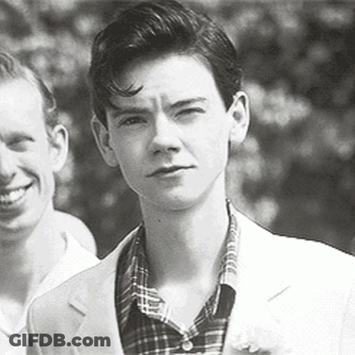 Black And White Photo Of Young Man In Suit Next To Another Man GIF