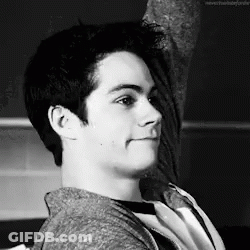 Black And White Photo Of Young Man Sitting On Chair GIF