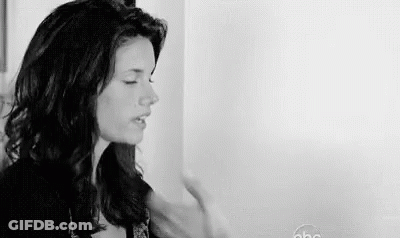 Black And White Photo Woman Eyes Closed Next To Wall GIF