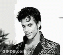 Black And White Prince In Suit And Necklace GIF
