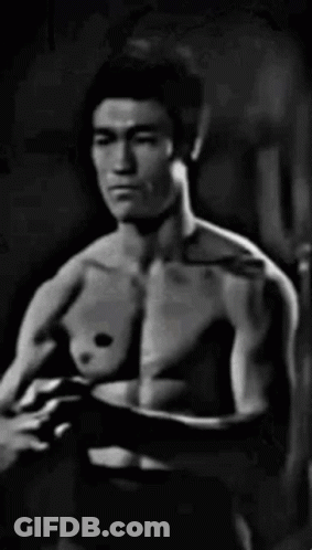 Black And White Shirtless Man In Dark Room GIF