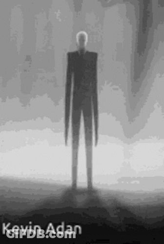 Black And White Slender Man Standing In Dark GIF