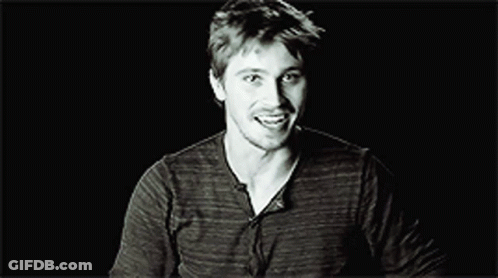 Black And White Smiling Man In Striped Shirt GIF