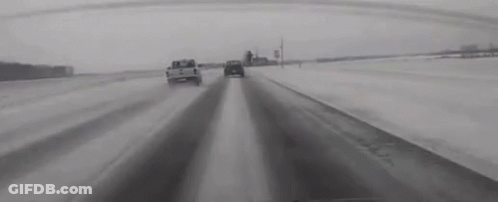 Black And White Snowy Highway With Cars GIF