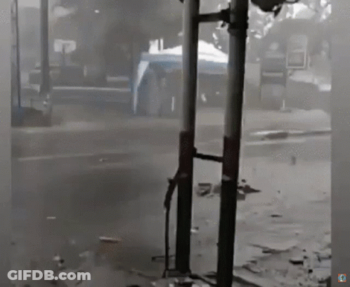 Black And White Street With Sign Saying A GIF