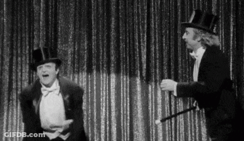 Black And White Two Men In Top Hats And Tuxedos On Stage GIF