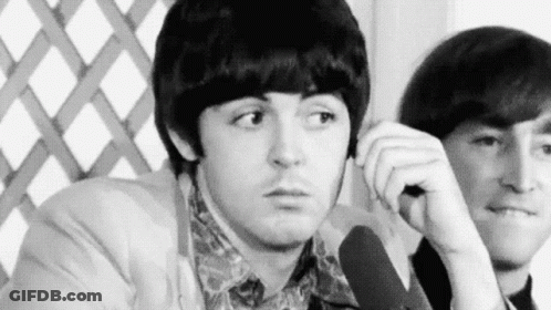 Black And White Two Men Sitting One Looking At Camera GIF
