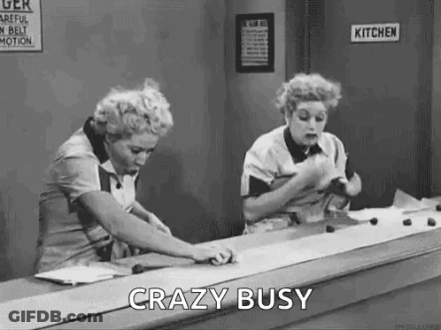 Black And White Two Women At Counter Saying Crazy Busy GIF