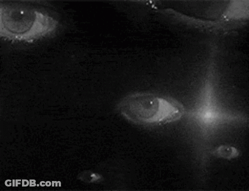 Black And White Violinist Before Large Eye Painting GIF