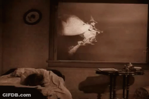 Black And White Witch On Broom In Bedroom GIF