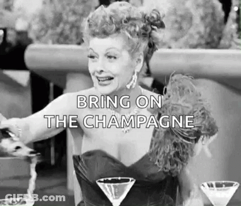 Black And White Woman At Table With Martini Glasses GIF