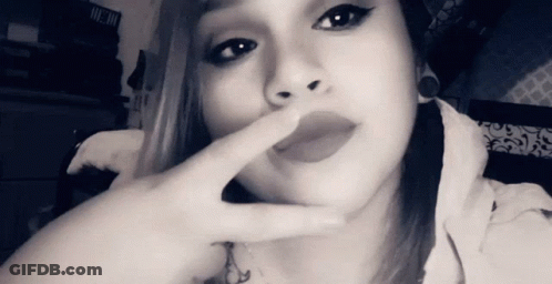Black And White Woman Covering Mouth With Finger GIF