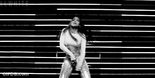 Black And White Woman Dancing In Front Of Wall With Lights GIF