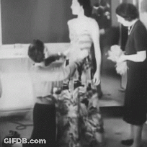 Black And White Woman Having Dress Adjusted GIF