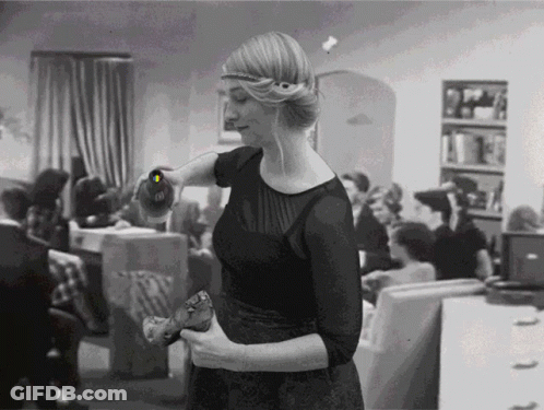 Black And White Woman Holding Bottle With Letter O GIF