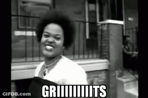 Black And White Woman In Front Of Griiiits Building GIF